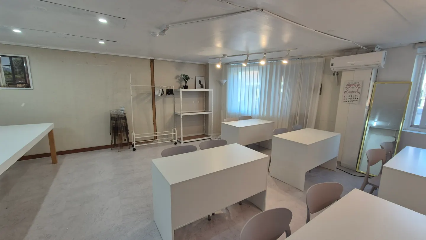 Another view of the white worktables inside Clover Baking Yeonnam